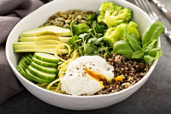 Colorful balanced bowl with vegetables and grains on a table